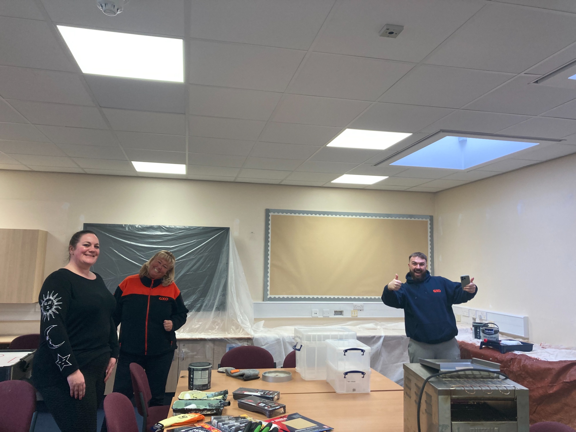 Photo of volunteers painting the community room